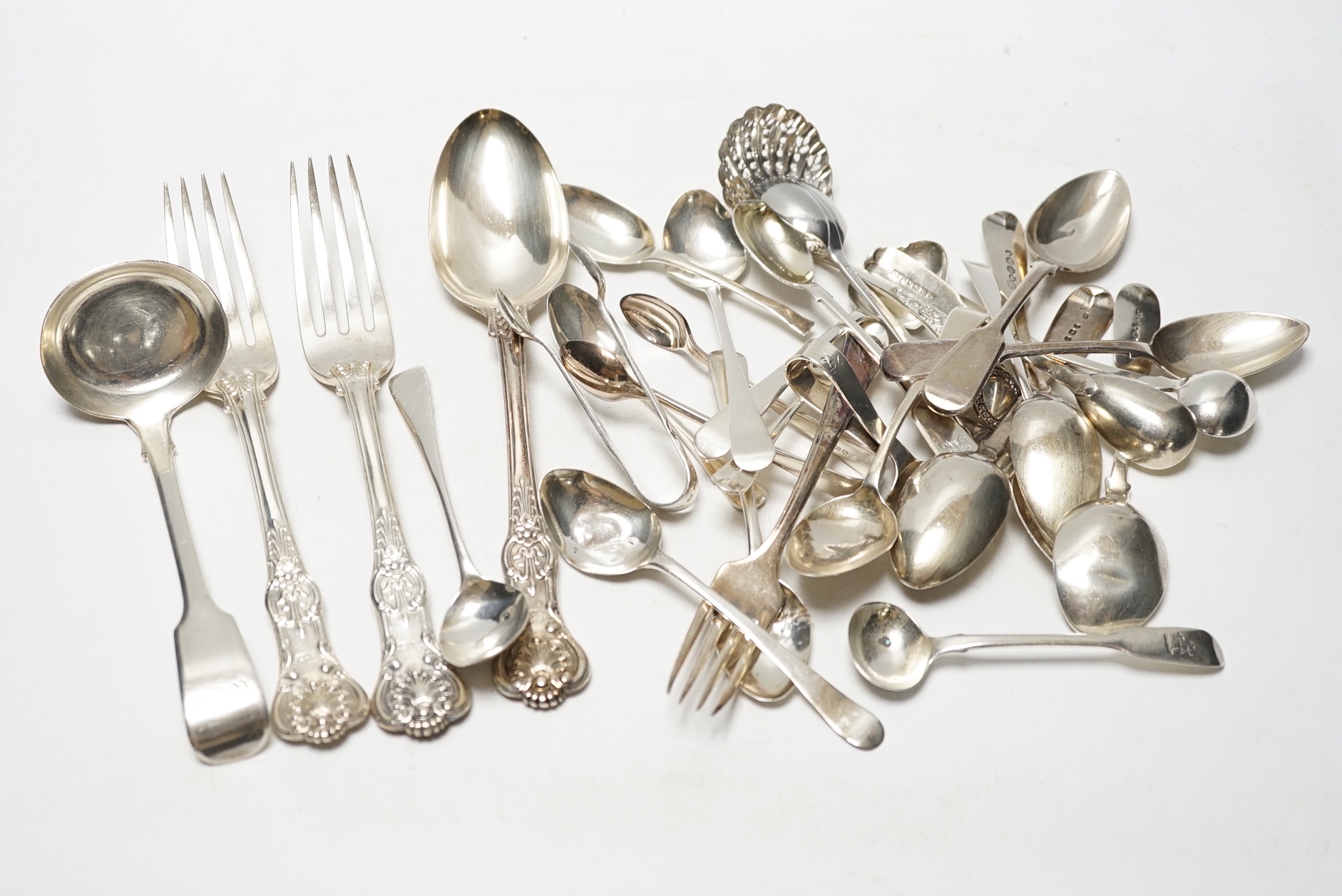 Sundry silver cutlery, including a pair of Victorian Kings pattern table forks and a matching tablespoon, London, 1845, a William IV fiddle pattern sauce ladle and various salt, tea and coffee spoons, 21.9oz and three pl